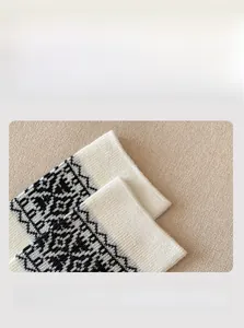 Detail of high-elasticity ribbed cuff on Fair Isle patterned warm winter socks