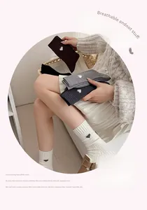 Detailed view of combed cotton socks with small heart embroidery and vertical ribs