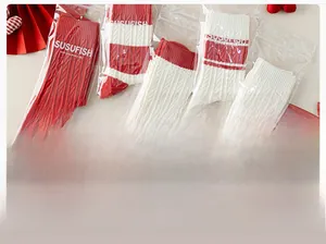 Detail of red and white striped cotton socks in transparent zip-lock packaging