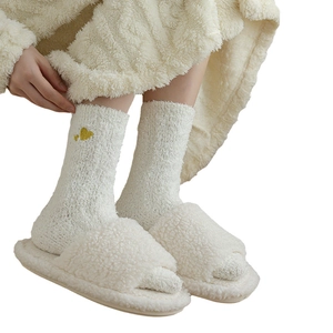 Plush coral fleece socks with yellow heart embroidery paired with white home slippers