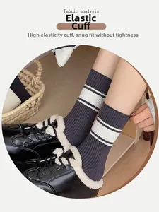 Detail of grey striped crew socks featuring elastic cuffs and soft knit cotton fabric