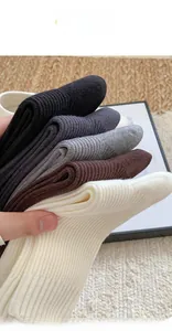 Close-up of thick rib-knit cashmere-like socks in assorted autumn neutral colors