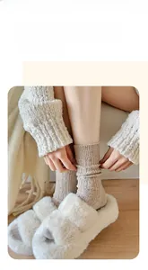 Detail of chunky knit beige crew socks with colorful flecks in a cozy home setting