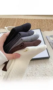 Close-up of five pairs of thick thermal cashmere socks in classic neutral colors