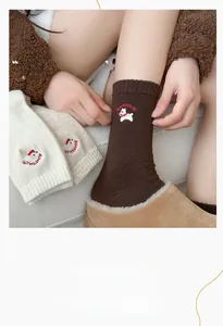 Close-up of cozy knitted wool socks featuring a cute puppy embroidery and ribbed cuffs
