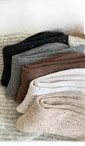 Detail showing knit texture of five pairs of warm twist-pattern socks in neutral colors