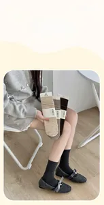 Close-up of ribbed wool blend socks in neutral tones styled with Mary Jane shoes