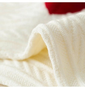 Close-up of thick white knitted fabric with 3D wave texture for warm winter socks