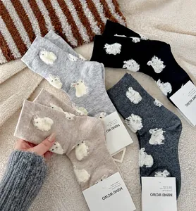 Detailed view of winter rabbit socks in gray and beige with 3D embossed rabbit pattern