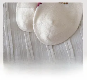 Detail of smooth flat-toe seam and knit texture on white cartoon animal socks