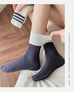 Close-up of combed cotton ribbed socks in grey and white with black stripes