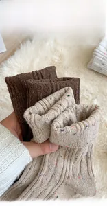 Close-up of thick knitted cable pattern and ribbed cuffs on warm winter socks