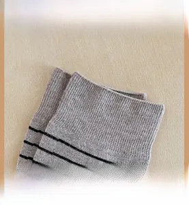 Detail of high-elasticity ribbed cuff on grey wool blend striped crew socks for women