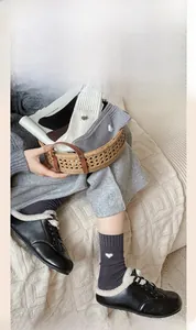 Detailed close-up of heart embroidery on cotton socks in cozy home setting