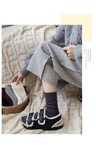 Detail of dark grey ribbed cashmere style socks paired with plush lined buckle sandals