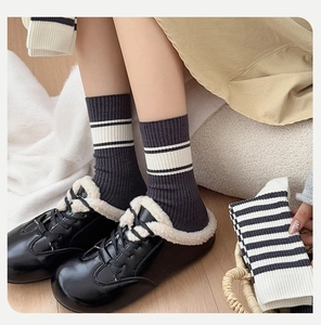 Detailed close-up of ribbed cotton crew socks with white stripes and cozy winter styling