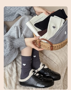Detailed knit texture of heart embroidered crew socks in various winter colors