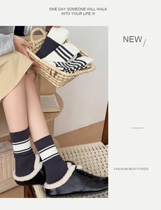 Detail of grey ribbed cotton crew socks with white stripes in a cozy winter setting