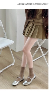 Silver Mary Jane flats paired with brown ribbed wool socks in a retro aesthetic