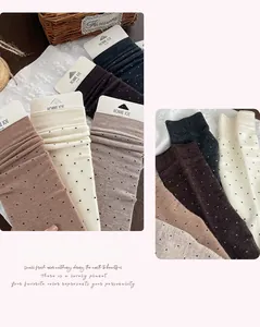 Detailed macro of wool socks in earth tones with black polka dots and ribbed cuffs