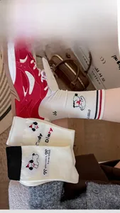 Close-up of ribbed cotton socks featuring cute cartoon dog embroidery and bow details