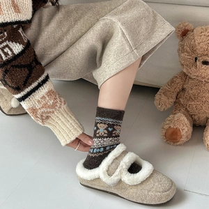 Cute Fair Isle bear wool socks with thick winter padding shown in a cozy home setting