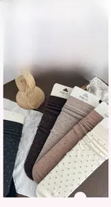 Detail of wool knit crew socks in five earth tones with subtle polka dot patterns