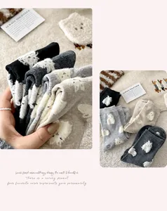 Close-up of fluffy velvet mid-calf socks with cute 3D bunny patterns in neutral tones