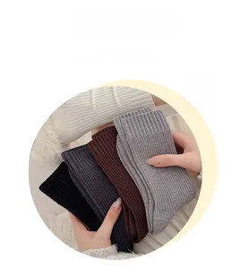 Detailed view of soft ribbed cashmere-like socks in black grey and brown knit colors