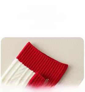 Detailed macro shot of red and white striped knit texture with thick ribbed cuffs