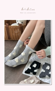Detail of cute velvet rabbit socks in four neutral colors with soft knit texture