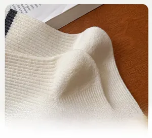 Detail shot of white ribbed knit cotton socks showing the ergonomic 3D heel construction