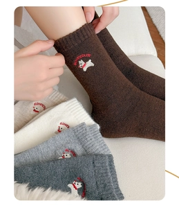 Close-up of wool blend socks featuring cute dog embroidery and HONEYCOLOR lettering