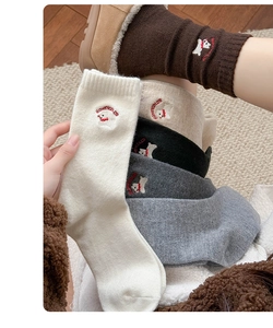 Close-up of wool blend socks featuring cute white dog embroidery and ribbed texture