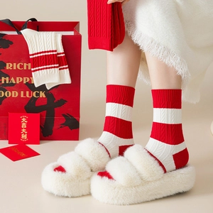 Festive red and white striped cable knit mid-tube socks with cozy warm texture