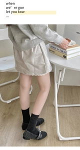 Detail of wool crew socks paired with grey lace skirt and ribbon flat shoes
