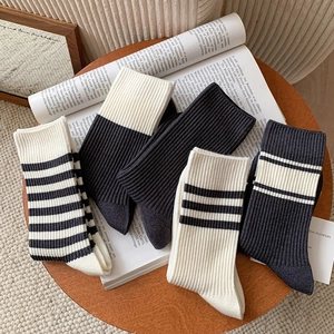 Classic black and white striped cotton mid-calf socks for women in minimalist style