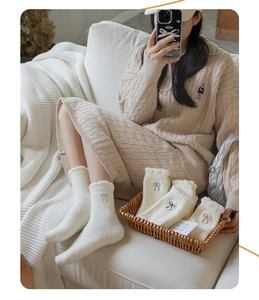 Detailed view of thermal white crew socks featuring cute bow embroidery and scalloped edges