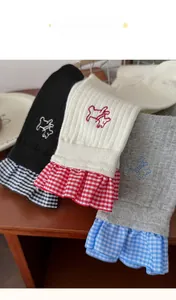 Detailed view of women's cotton crew socks with puppy embroidery and plaid ruffle edge