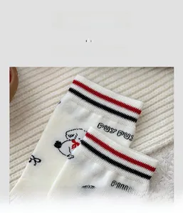 Detailed close-up of high-elasticity ribbed cuff on white cartoon puppy socks