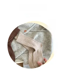 Detail of oatmeal cable knit socks with colorful speckle yarn for winter warmth