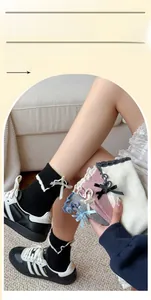 Close-up of ruffled cuff socks with silk bows and ribbed texture in multiple colors