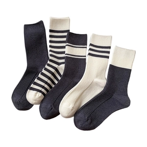 Set of five black and white striped cotton crew socks with ribbed texture for daily wear