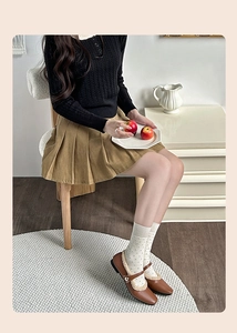 Polka dot wool socks paired with khaki pleated skirt and brown Mary Jane shoes
