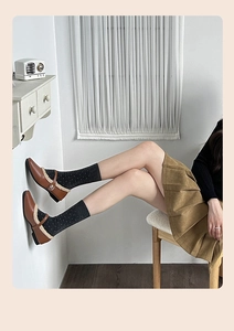 Close-up of brown Mary Jane shoes with fleece lining and dark gray polka dot socks