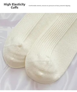 Macro detail of elastic ribbed cuff on off-white cashmere-like warm winter socks