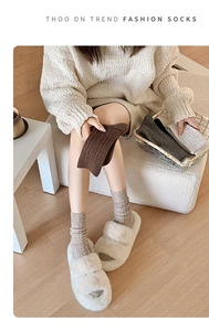 Detail of warm cable knit crew socks in earth tones for autumn and winter wear