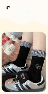 Detail of knit socks with dog embroidery, plaid ruffle trim and silver sneakers