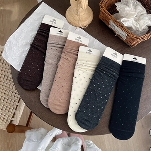 Six pairs of thick wool crew socks in assorted colors with white polka dot patterns