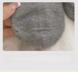 Close-up of seamless toe stitching and blue star pattern on gray wool blend socks